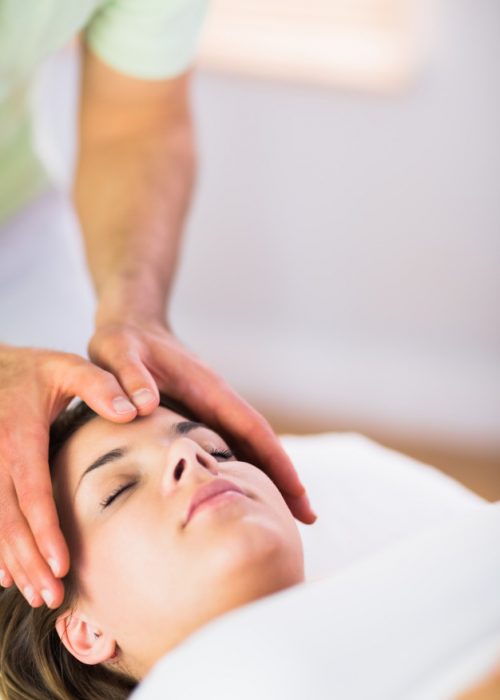 relaxed-pregnant-woman-getting-reiki-treatment_13339-153184